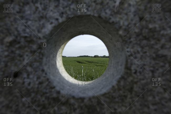 A remote natural landscape seen through a hole in granite