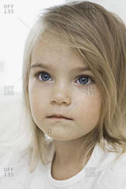 A young girl with a wet cheek from crying