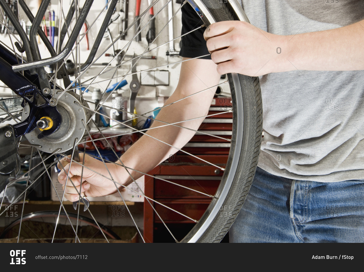 Detail of a man repairing a bike