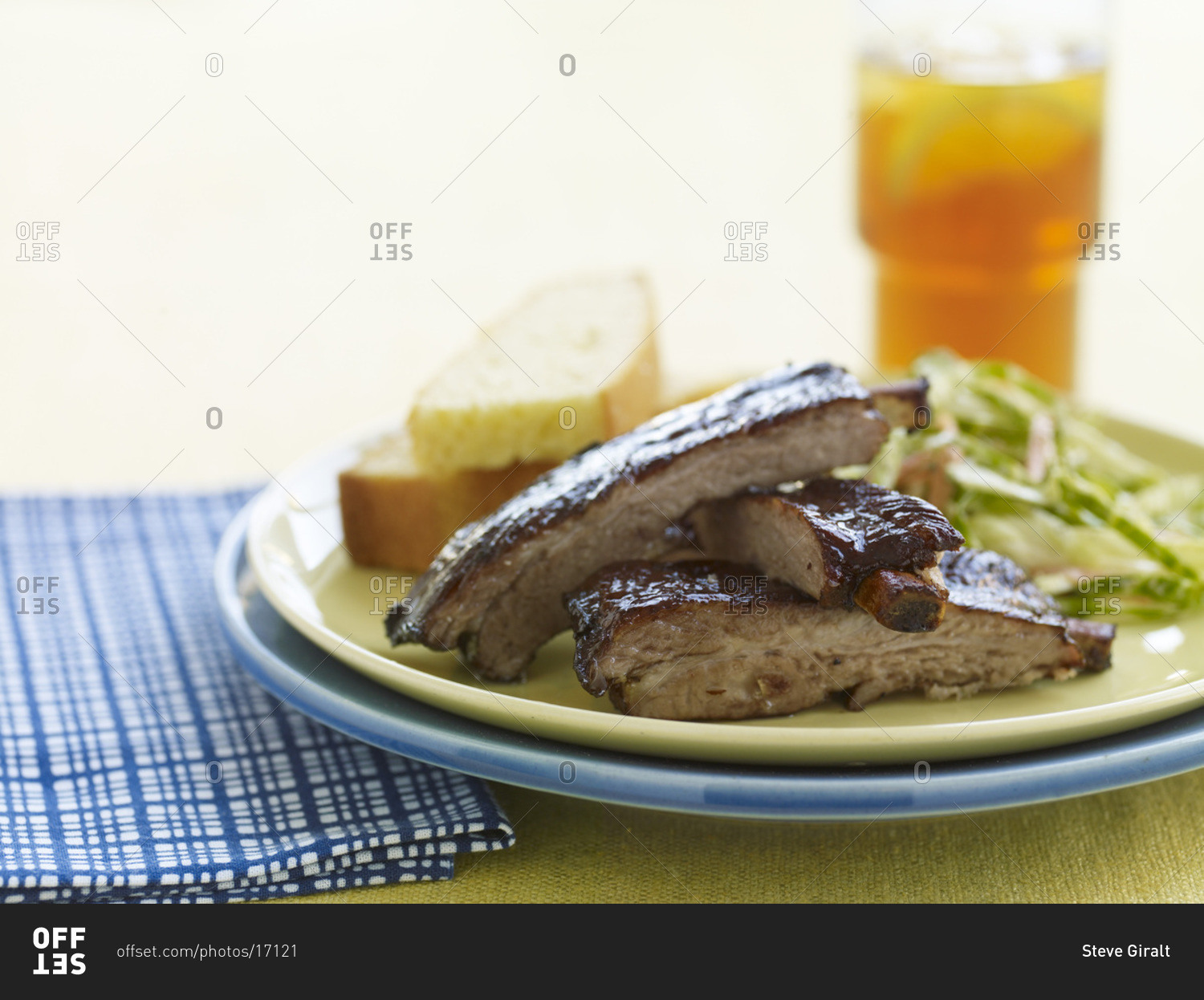 Grilled pork rib chops on plate with a glass of beer.