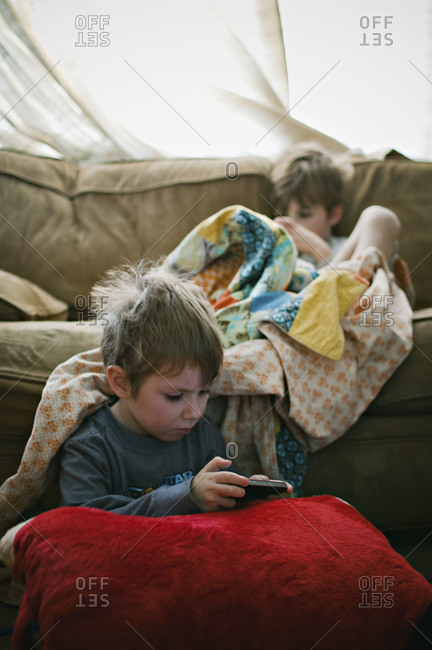 Two boys playing video games in morning