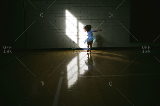 Little girl dancing in shadow