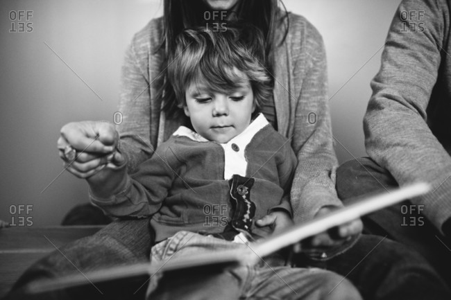 Mom reading book to little boy