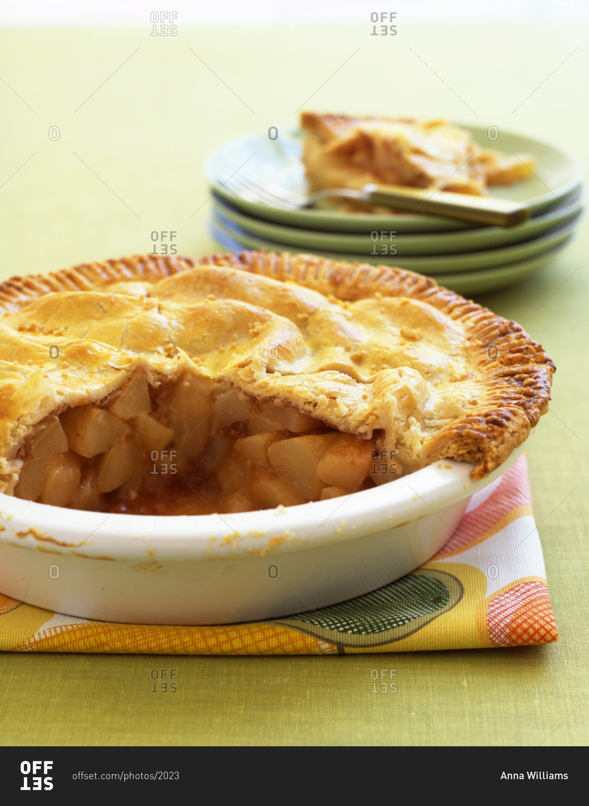 Homemade apple pie in a white tart dish.