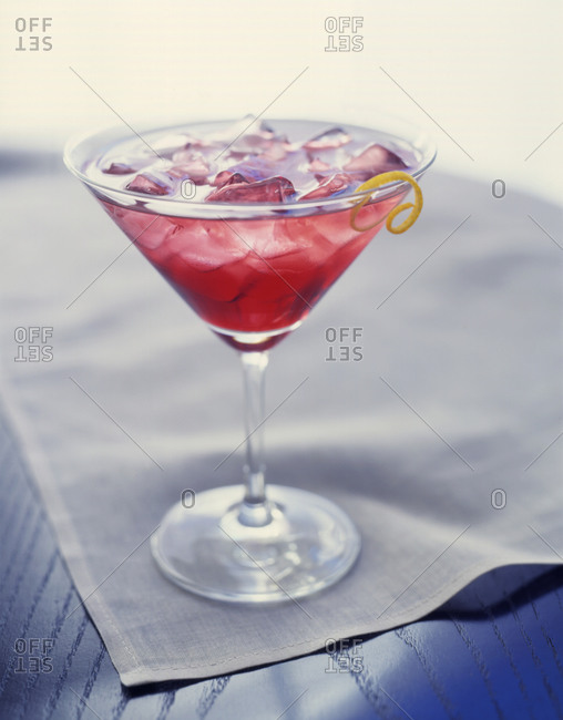 Cocktail with ice cubes on a table cloth