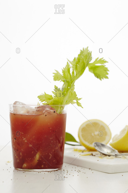 Bloody Mary cocktail garnished celery, served with ice cubes
