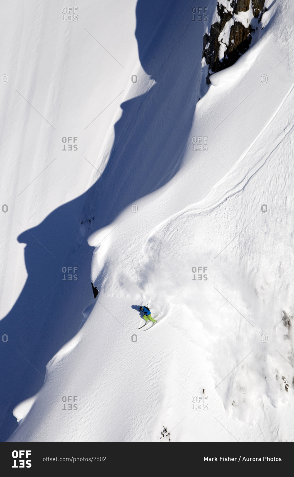 A male extreme skier skis a big mountain first descent in Haines, Alaska