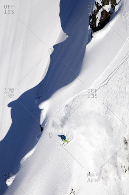 A male extreme skier skis a big mountain first descent in Haines, Alaska
