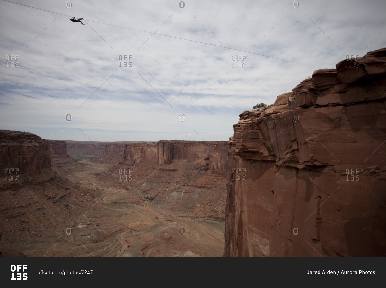 Highlining at the Fruit Bowl in Moab, Utah stock photo OFFSET