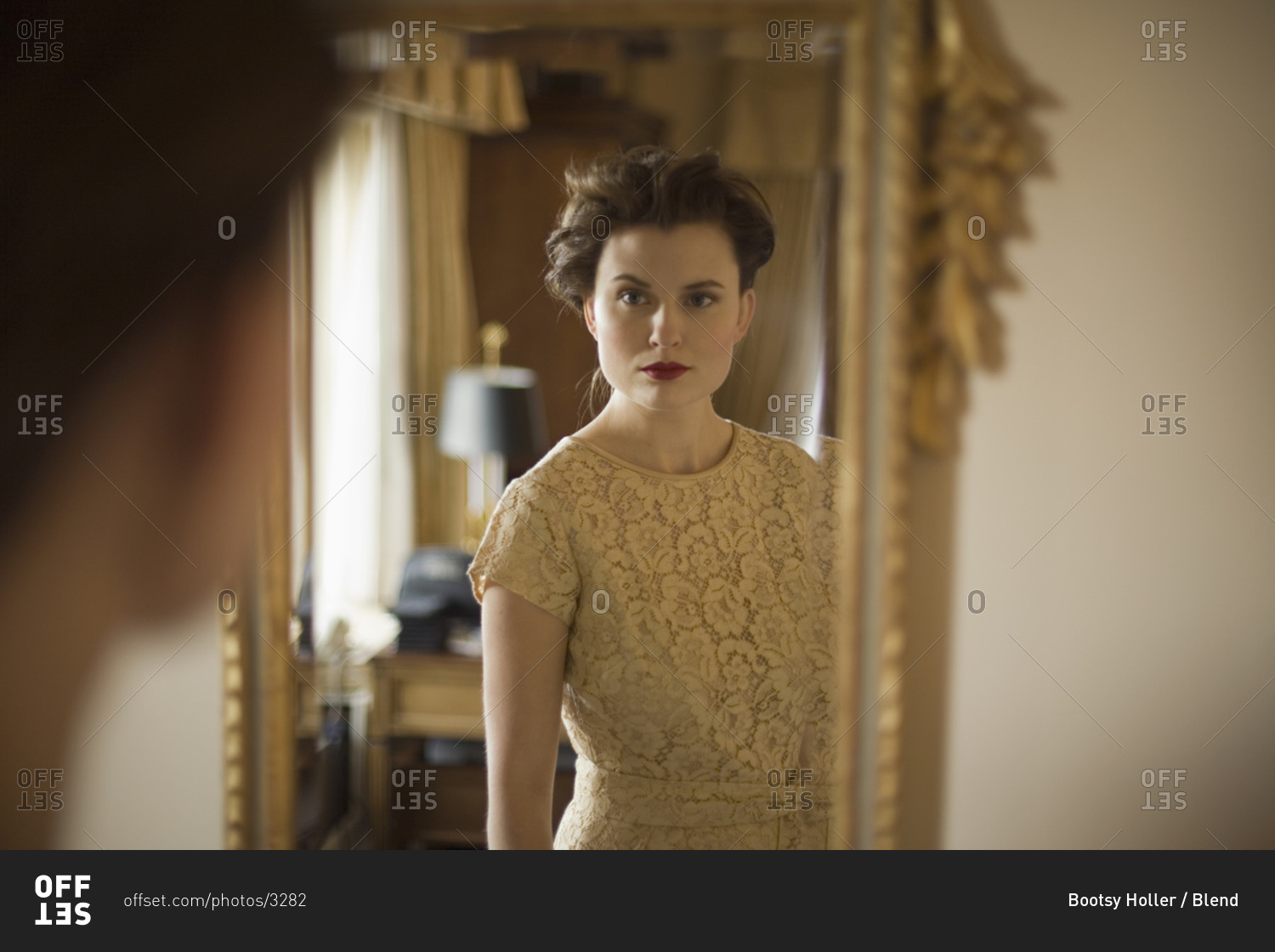 Woman wearing fancy dress looking in mirror