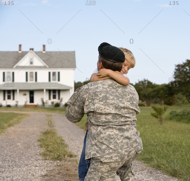 Military father hugging son