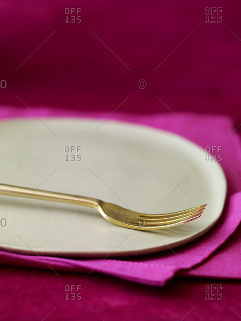 Close up of a fork on an empty plate