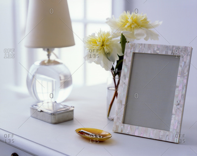 Empty photo frame on a white commode