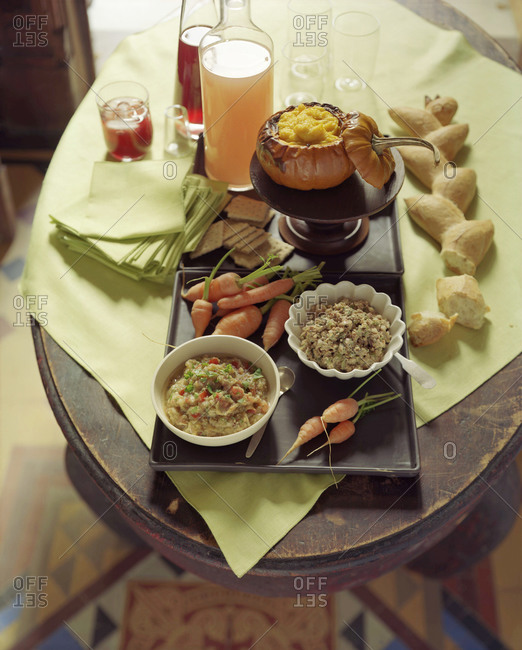 Various side dishes on an oval-shaped wooden table.