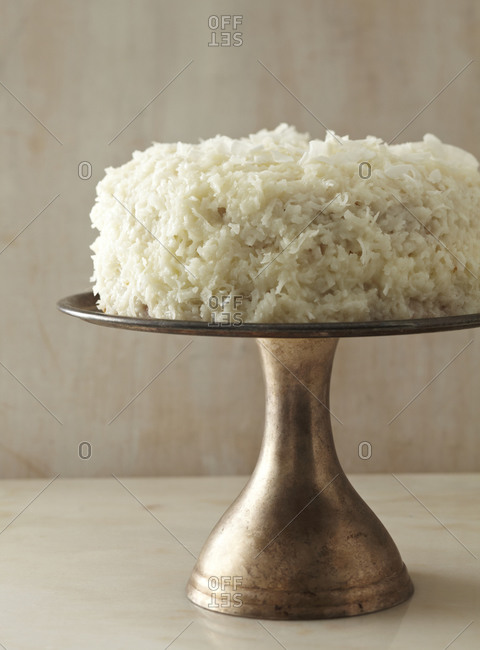Coconut cake on a vintage cake stand.
