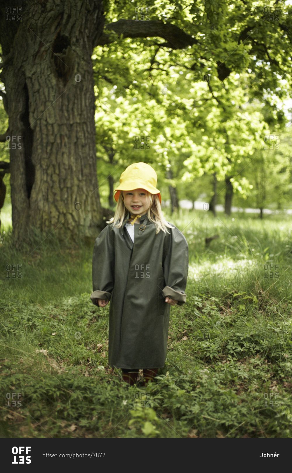 Girl wearing rain clothes in the forest
