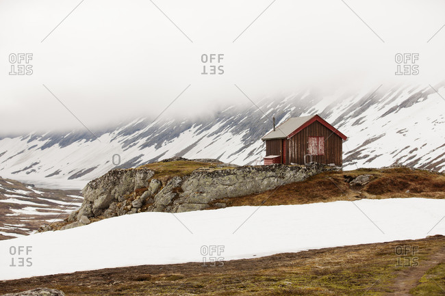 Wooden House in foggy mountains