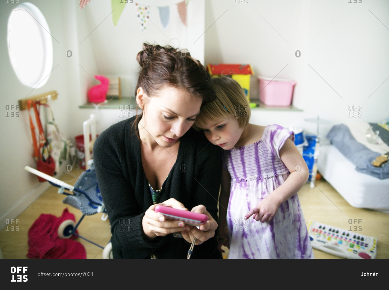 Mother with daughter looking at cell phone