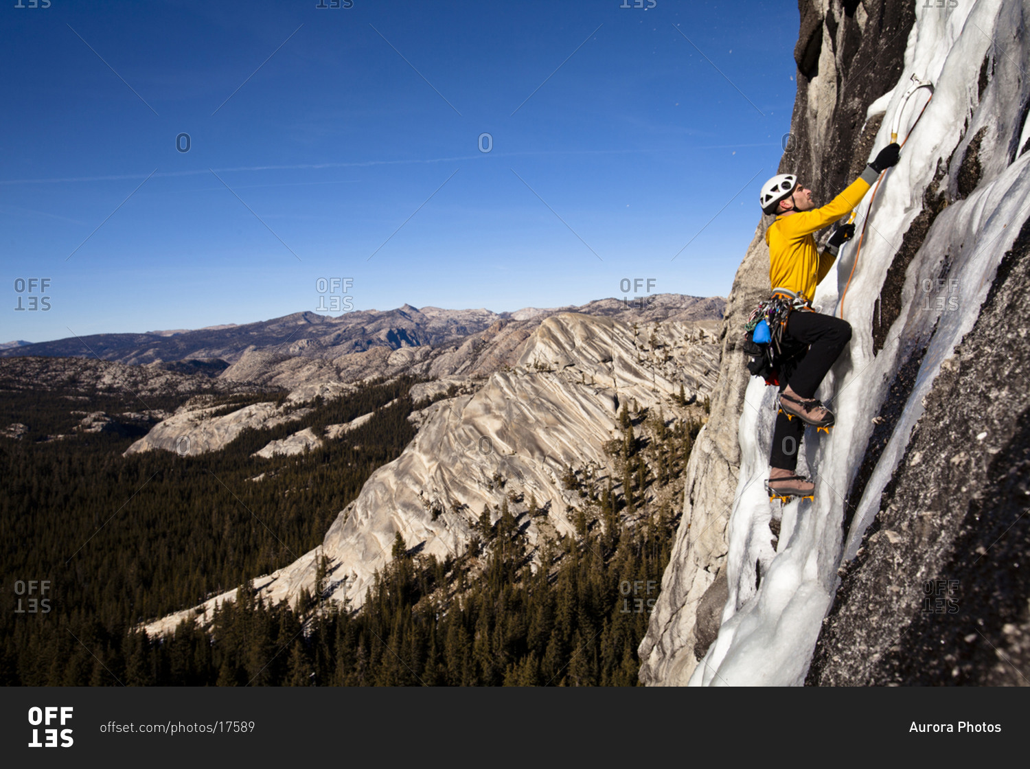 An ice climber climbs Yellow Brick Road (WI3+) on Drug Dome in Tuolumne Meadows located inside Yosemite National Park, California.