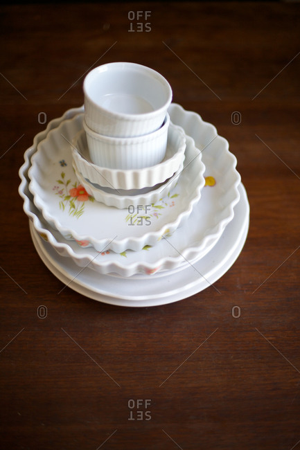 White vintage stacked dishes on a wooden surface
