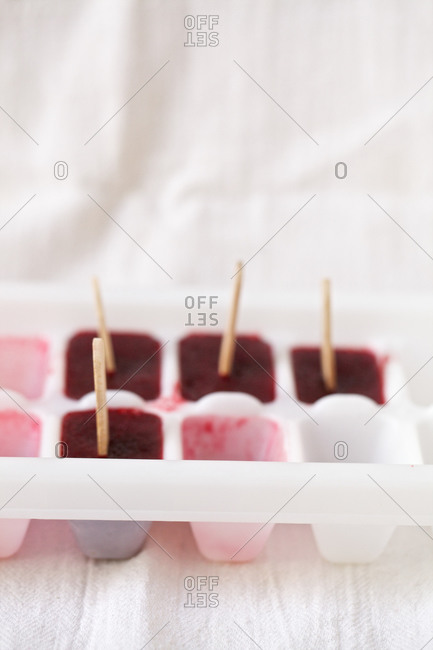 Mixed berry ice pops in ice cube tray
