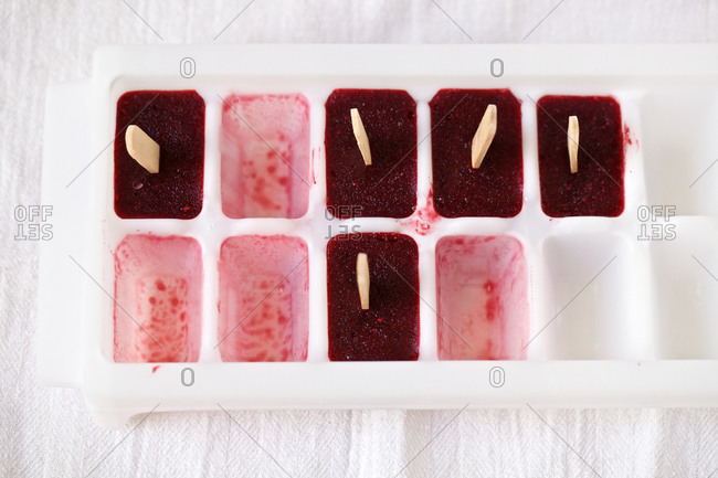 Mixed berry ice pops in ice cube tray