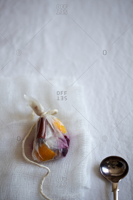 Homemade fruit teabag and a spoon