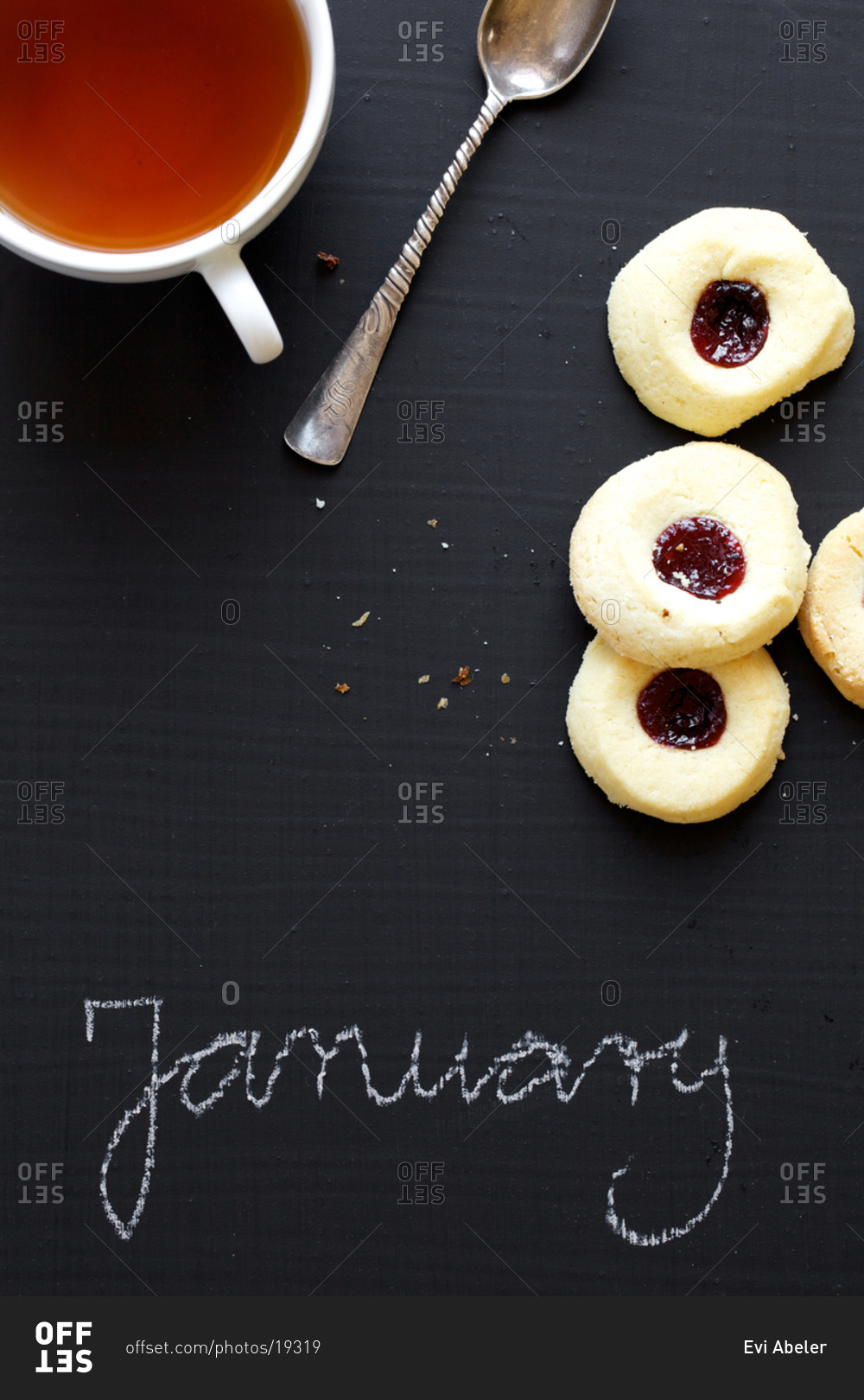 Tea, cookies and January word written on blackboard