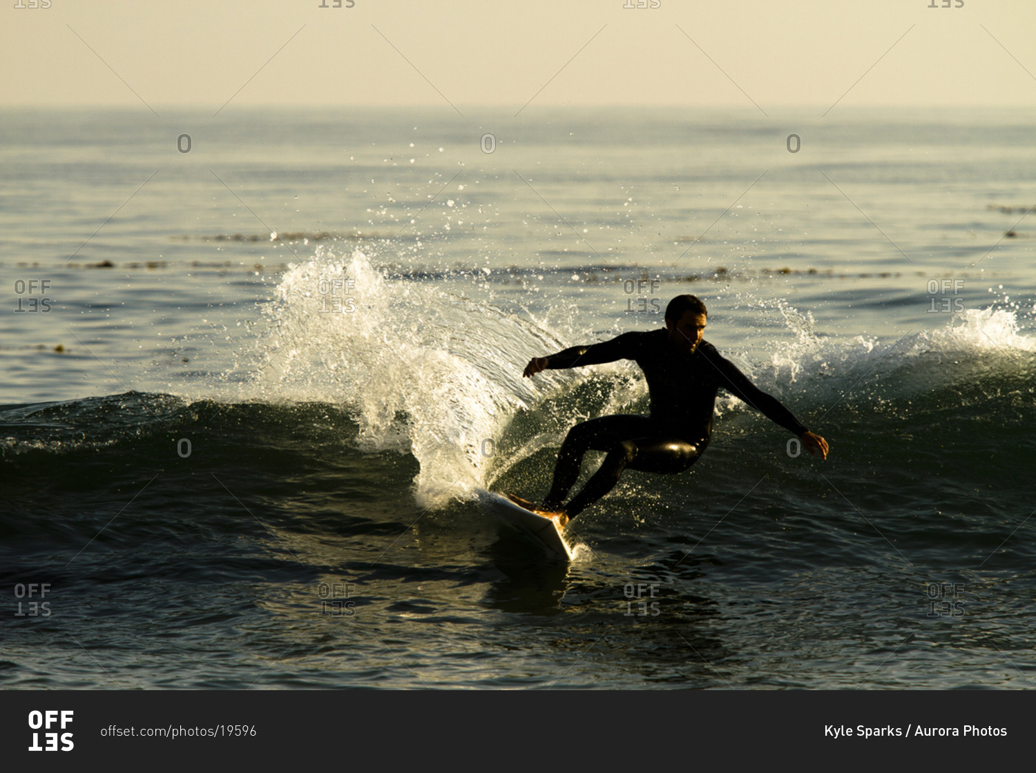 A male surfer rips a turn while surfing in Malibu, California.