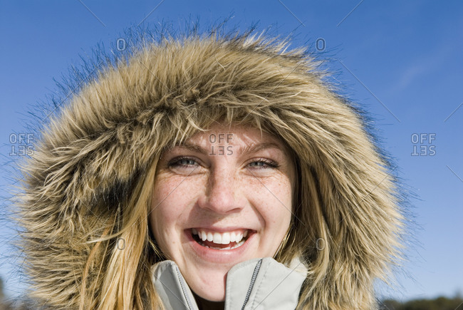 Woman outside wearing furry hood