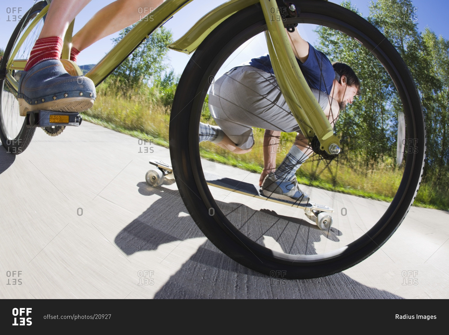 Woman Riding a Bicycle and Man Riding a Skateboard on a Bike Path, Steamboat Springs, Routt County, Colorado, USA