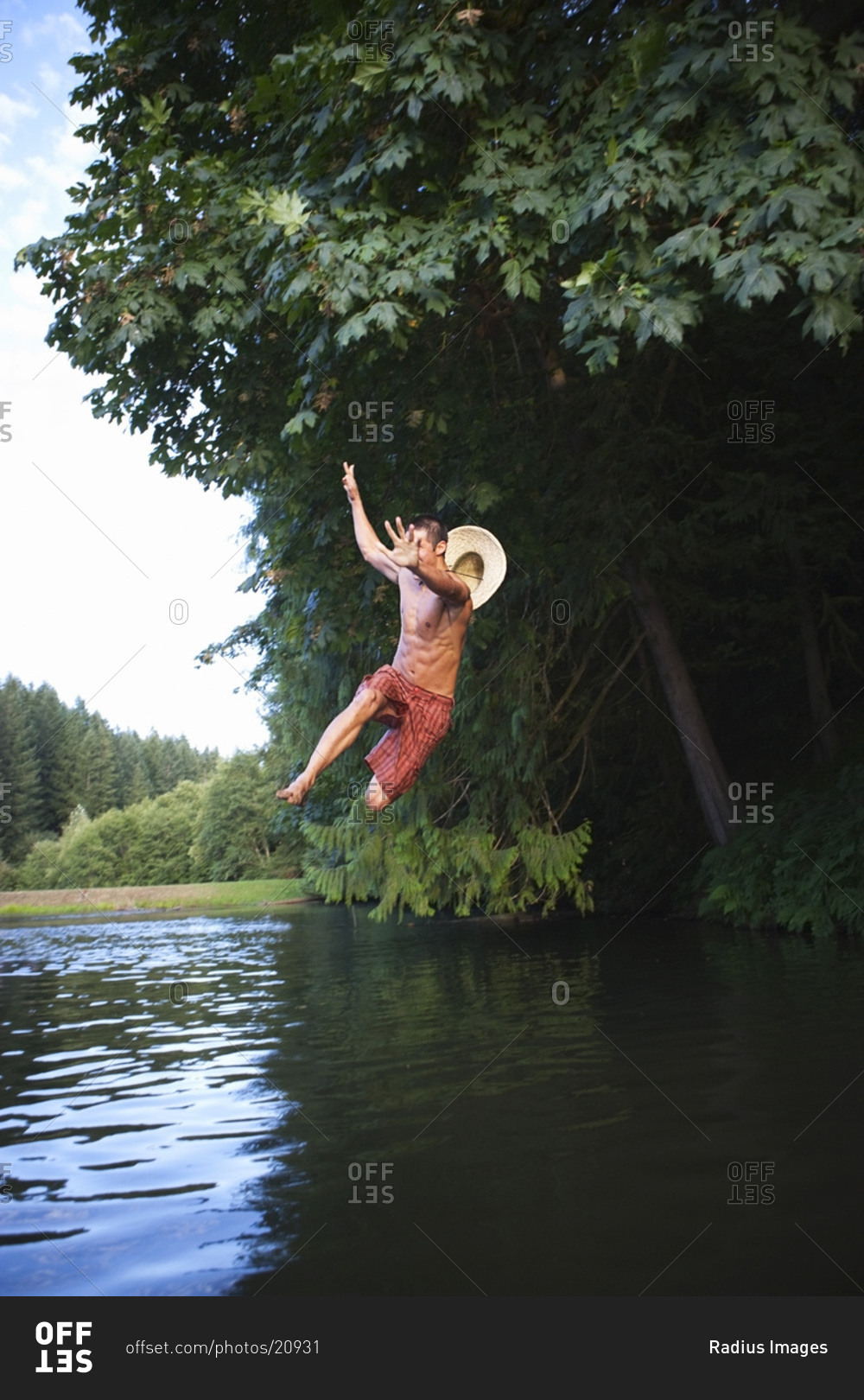 Teenage Boy Jumping Into Lake, Near Portland, Oregon, USA