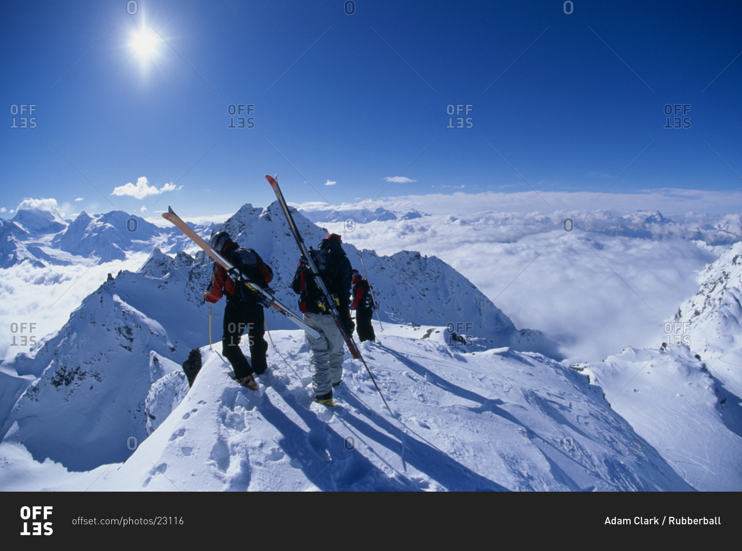 Two people with skis on mountain in winter