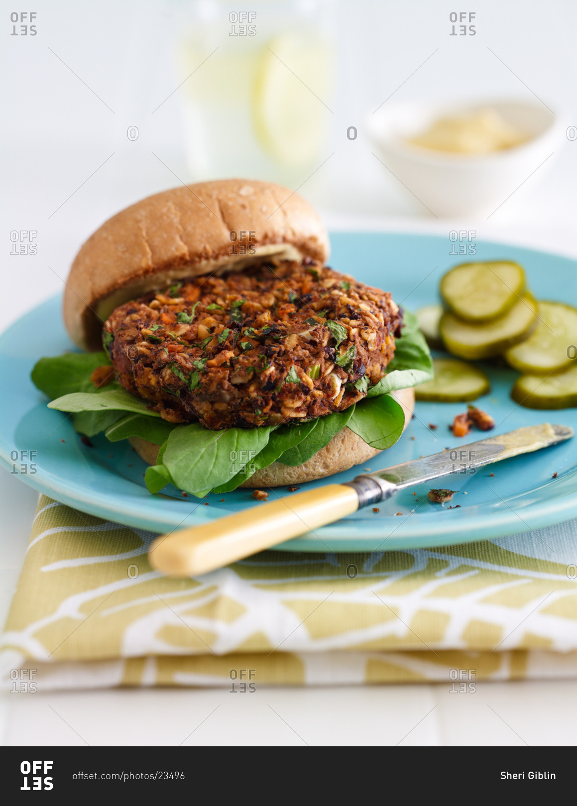 Black-bean Oatmeal Burger Served on Blue Plate with Pickles
