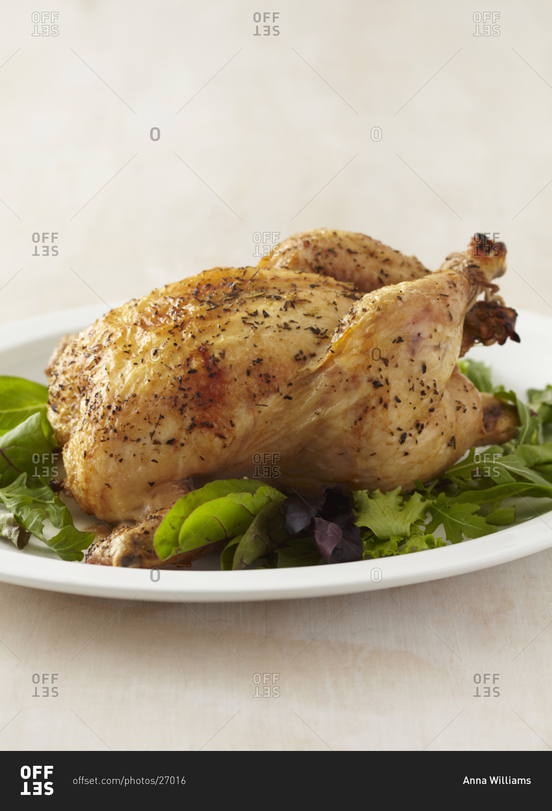 Whole herb roasted chicken over greens
