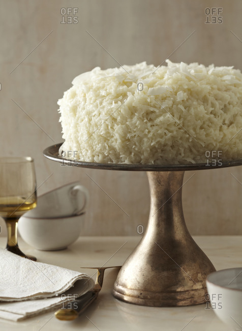 Coconut cream cake on a vintage cake stand