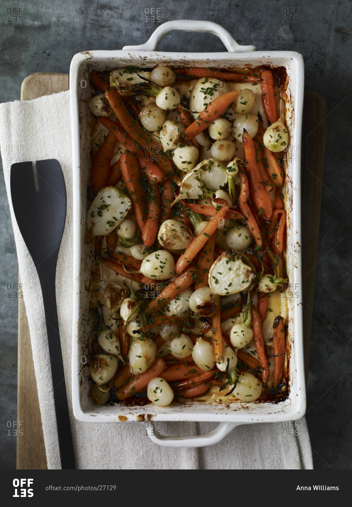 Roasted carrot, pearl onion, radish in a dish, seasoned with finely chopped chives