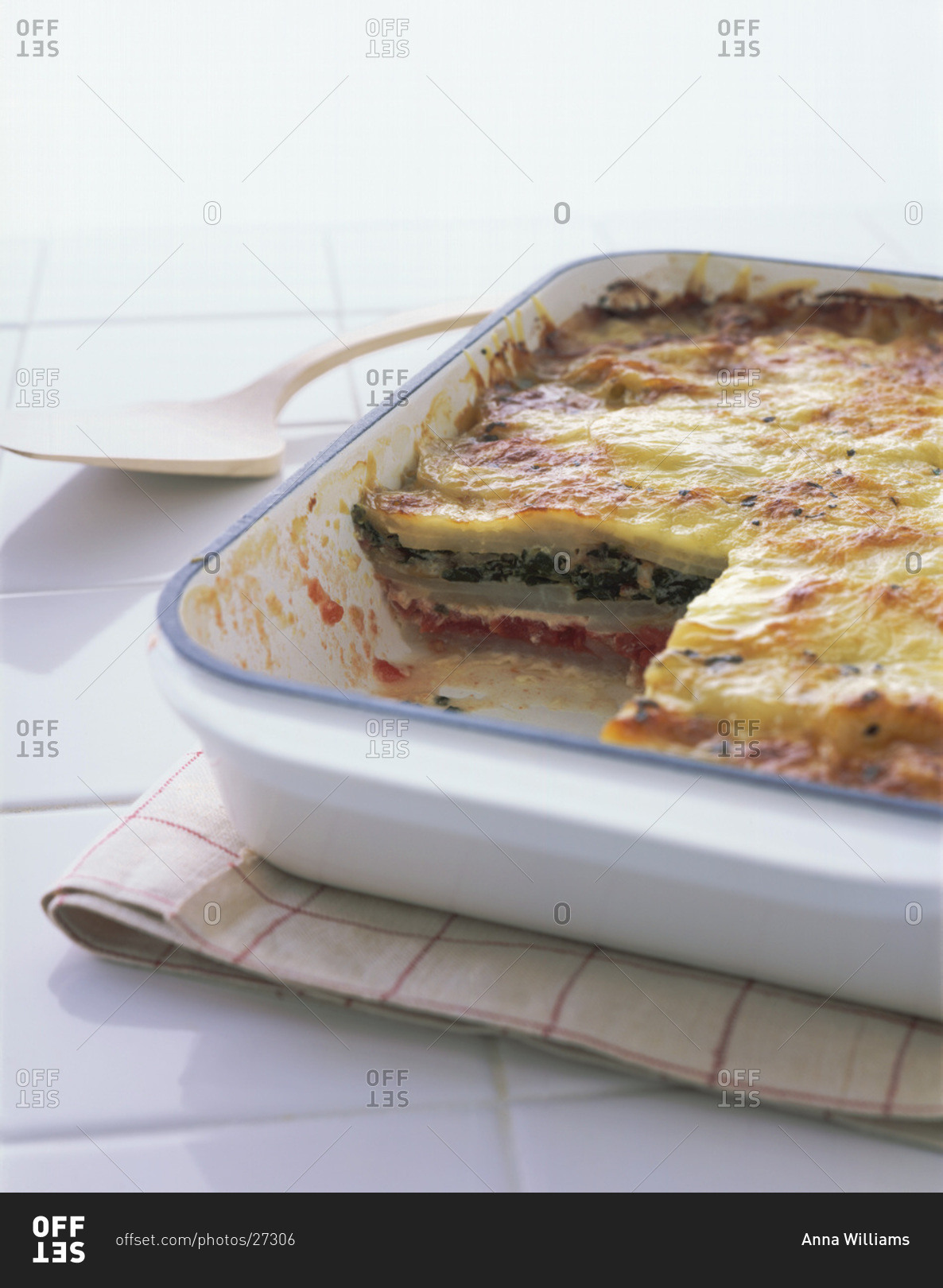 Vegetable lasagna with broccoli and tomatoes in casserole dish