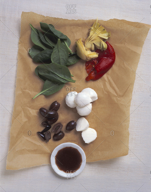 Composition with vegetables and mozzarella cheese displayed on textured paper