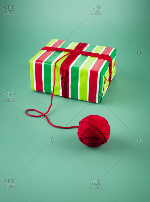 Present wrapped and tied with red yarn