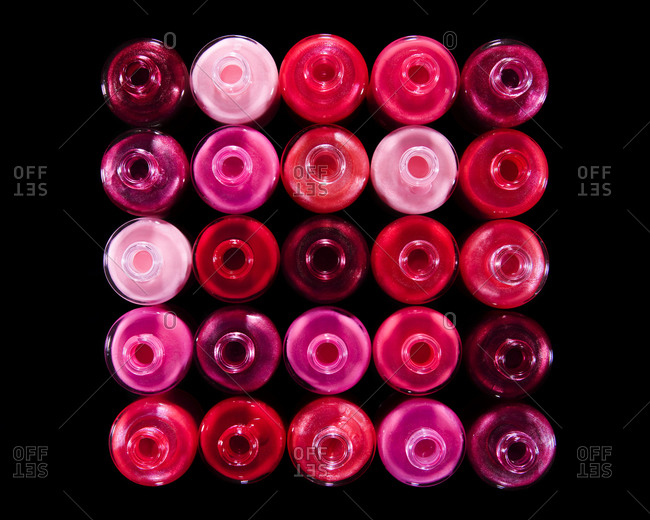 25 red nail polish bottles shot from above