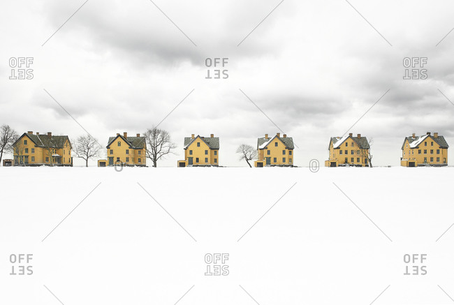 Row of houses on a snowy field