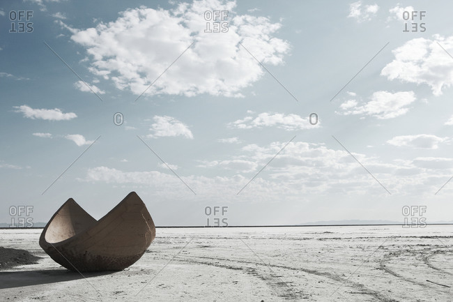 A view of a salt flat, an artifact and some wheel tracks
