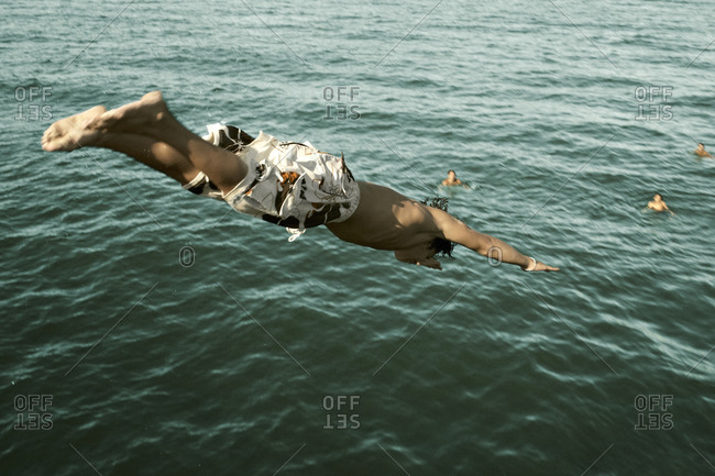 Man dives into a lake