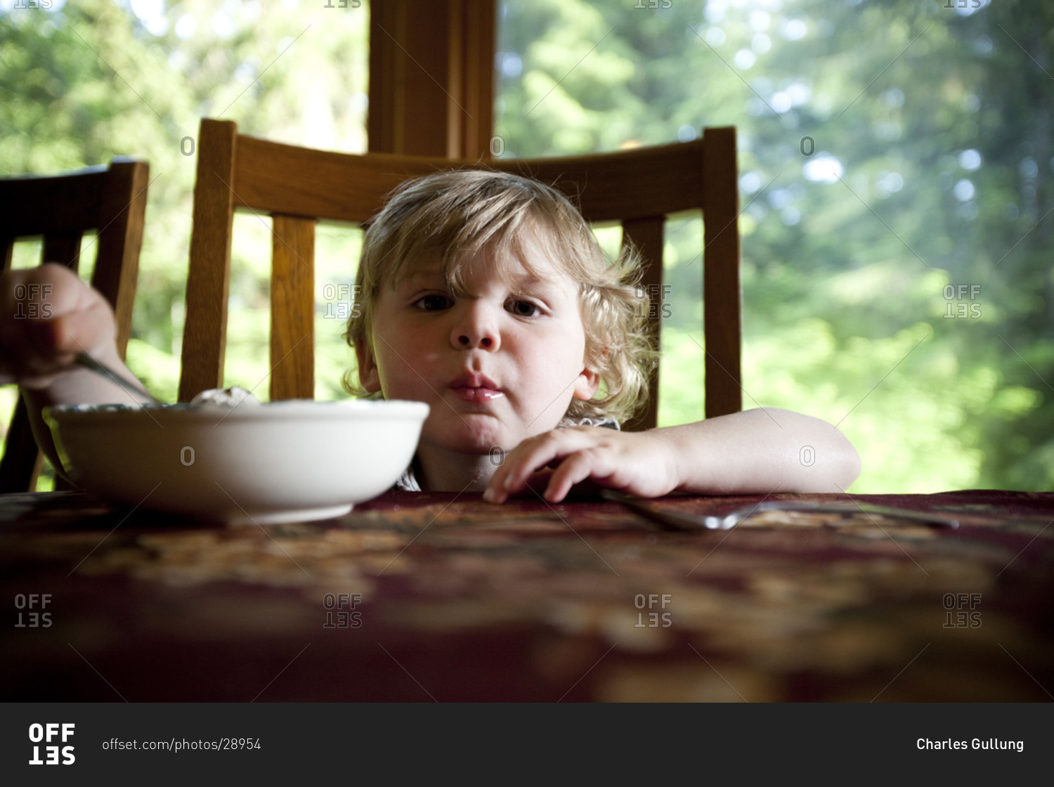 adorable-little-kid-eating-cereal-for-breakfast-in-the-dining-room