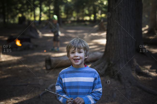 a portrait of a boy outside in the woods