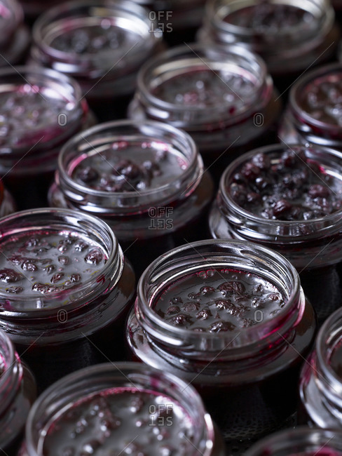 Close up of fresh cherry jam in glass jars