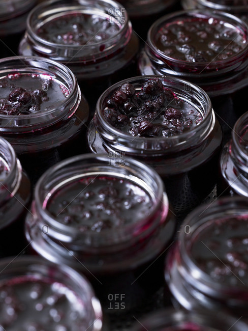 Close up of fresh cherry jam in glass jars