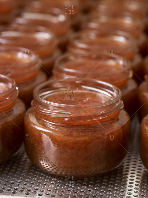 Close up of glass jars filled with rhubarb jam