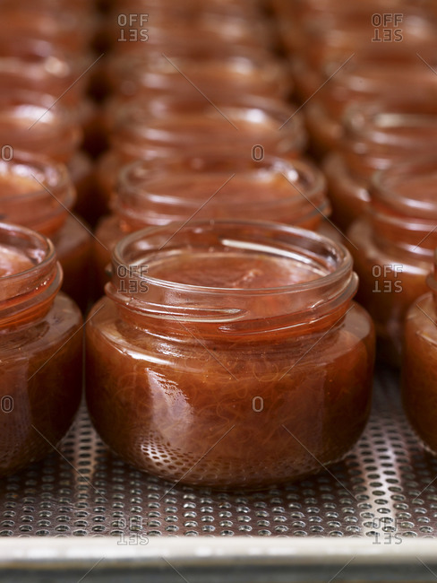 Close up of glass jars filled with rhubarb jam